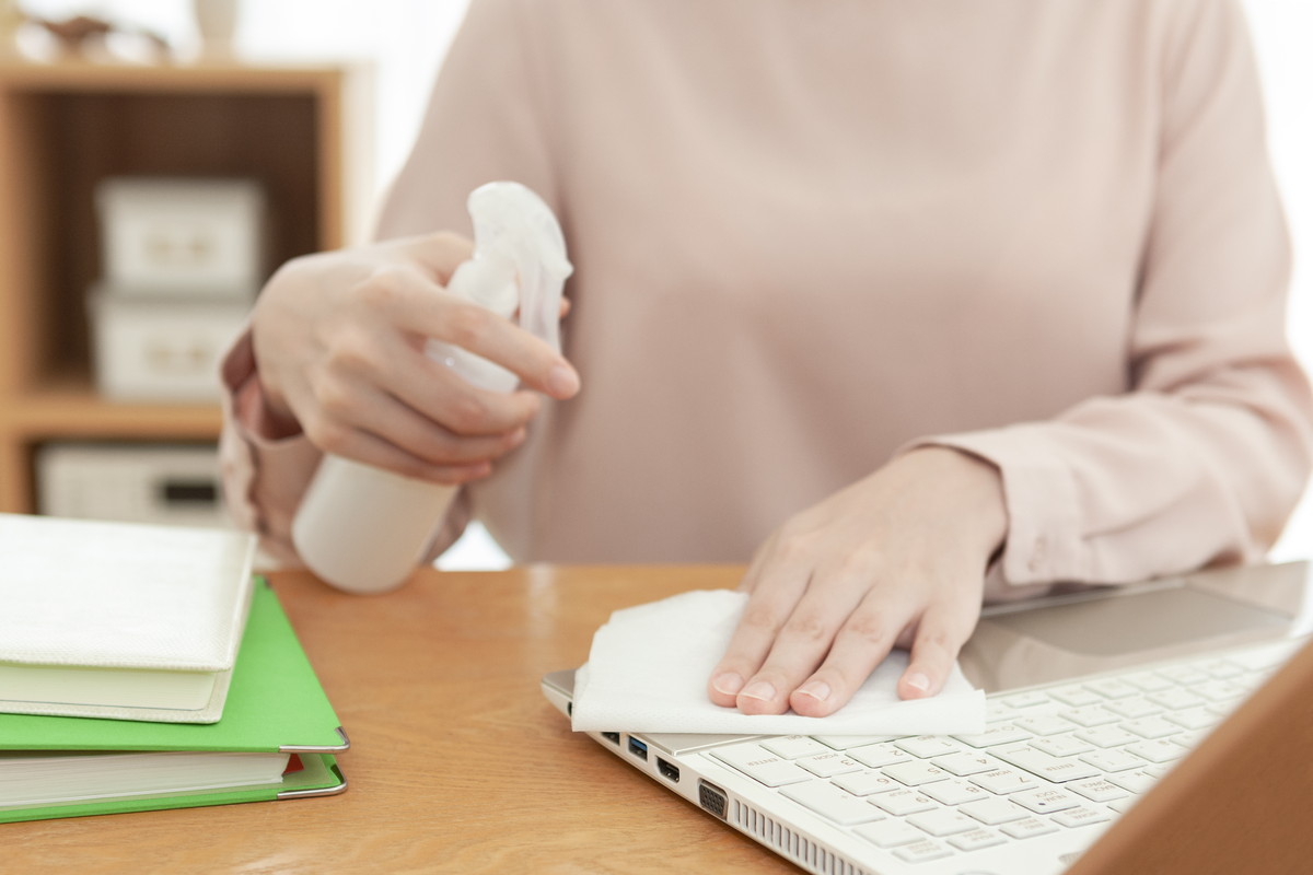 ノートパソコンを除菌スプレーで拭き取る